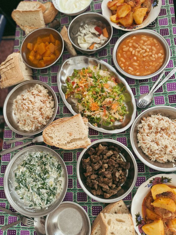 Delicious assortment of Mediterranean dishes with vibrant salads and warm bread.