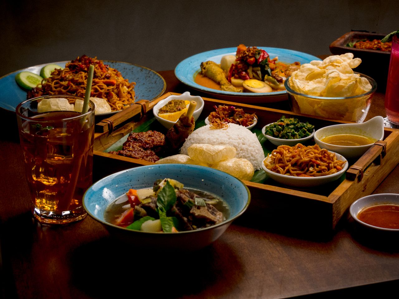 A variety of traditional Indonesian dishes beautifully arranged on a table, offering a culinary feast.